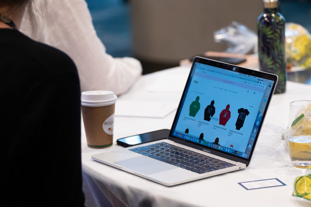 Laptop on a delegate's table showing an online shop, State of Social ’20