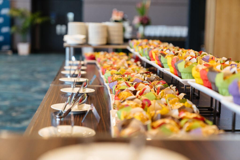 Long table of colourful fruit and desserts on the catering line, State of Social ’21