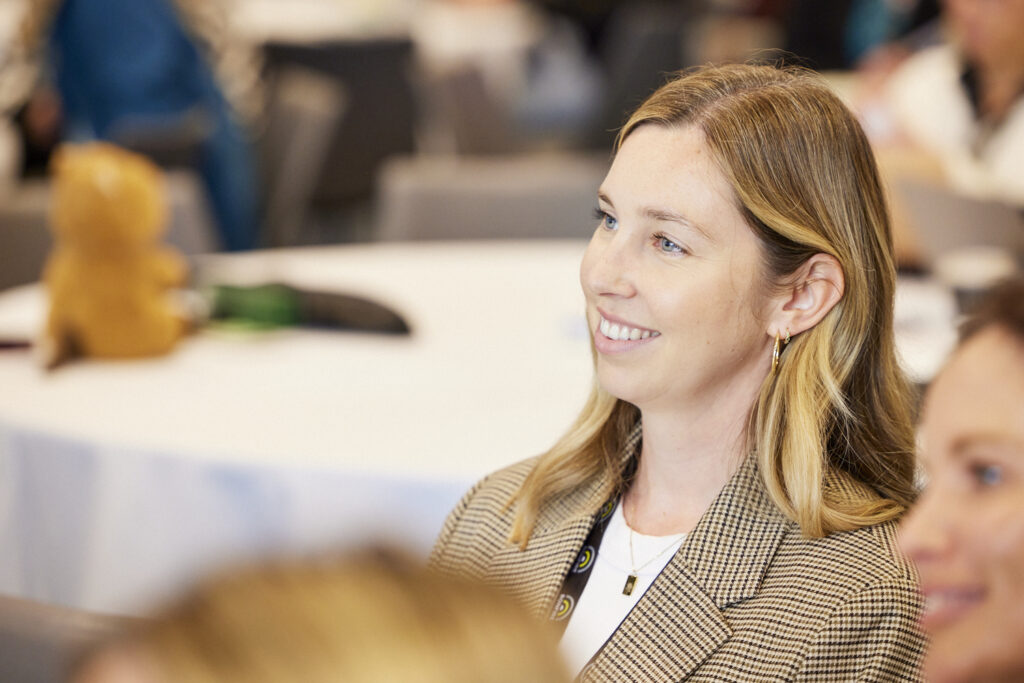 Smiling delegate listens during a session, State of Social ’23