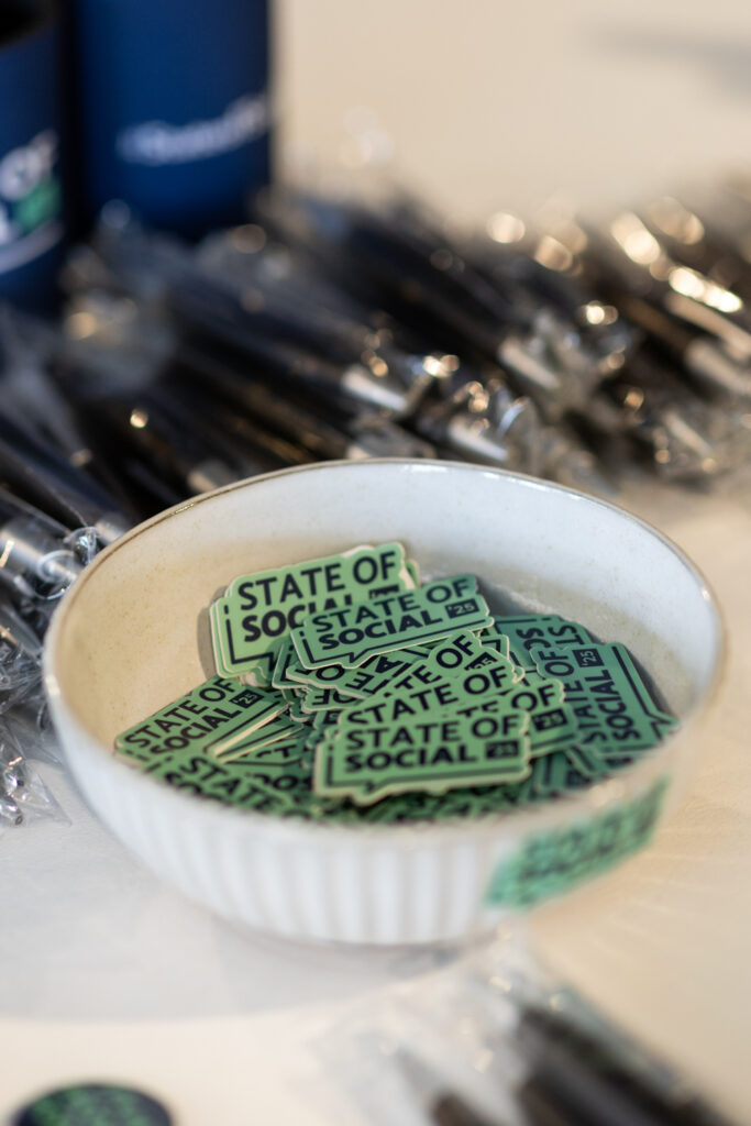 Bowl of green State of Social branded lollies on a table, State of Social ’25