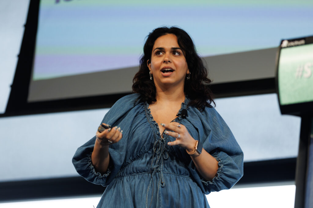 Speaker in a blue dress gestures as she speaks, State of Social ’26
