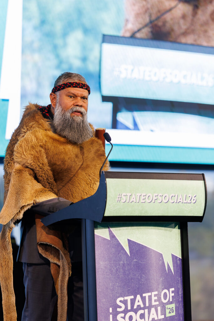 Man in a fur cloak speaks at the State of Social lectern, State of Social ’26