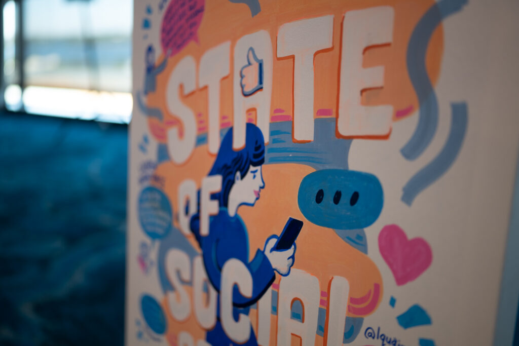 SOS20 mural by Cameron Jones: State of Social hand-lettered beside a figure on a phone